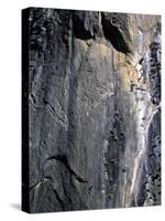 Climber Perched on Large Rock Wall, Madagascar-Michael Brown-Stretched Canvas