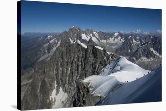 Climbers on a snowfield approaching the Aiguile du Midi, 3842m, Graian Alps, Chamonix, Haute Savoie-James Emmerson-Stretched Canvas