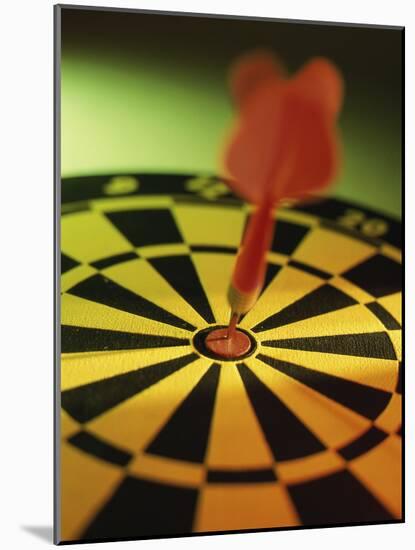 Close-up of a Dart in the Bull's-Eye of a Dartboard-null-Mounted Photographic Print