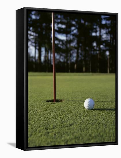 Close-up of a Golf Ball Near the Hole-null-Framed Stretched Canvas