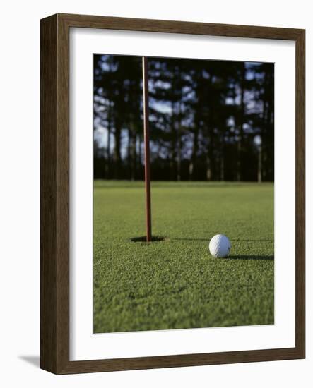 Close-up of a Golf Ball Near the Hole-null-Framed Photographic Print