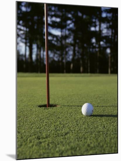 Close-up of a Golf Ball Near the Hole-null-Mounted Photographic Print