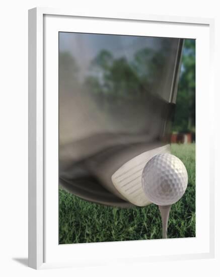 Close-up of a Golf Club Hitting a Golf Ball on a Tee-null-Framed Photographic Print