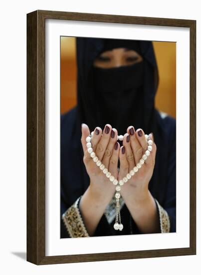 Close up of a Muslim woman's hands in abaya while holding rosary and praying, United Arab Emirates-Godong-Framed Photographic Print