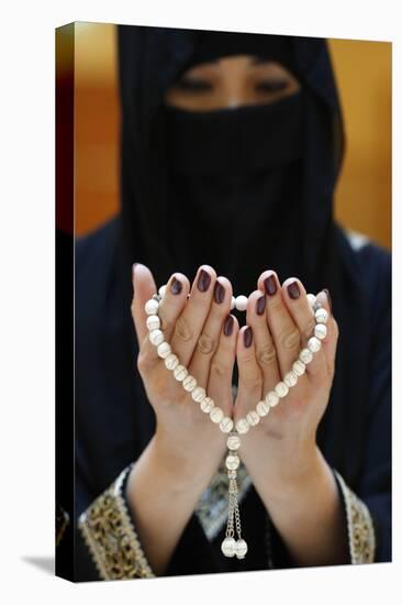 Close up of a Muslim woman's hands in abaya while holding rosary and praying, United Arab Emirates-Godong-Stretched Canvas