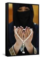 Close up of a Muslim woman's hands in abaya while holding rosary and praying, United Arab Emirates-Godong-Framed Stretched Canvas