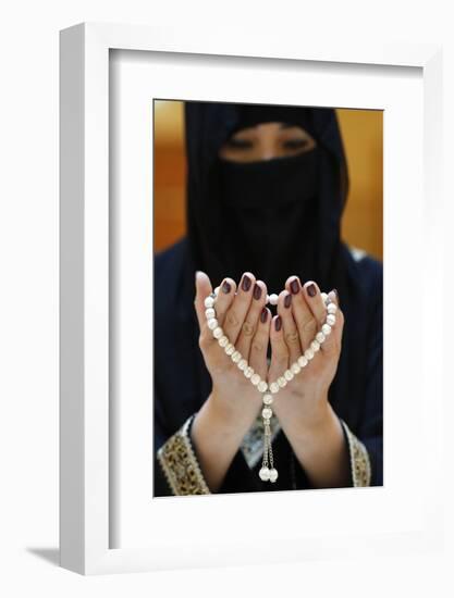 Close up of a Muslim woman's hands in abaya while holding rosary and praying, United Arab Emirates-Godong-Framed Photographic Print