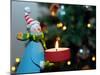 Close-Up of a Snow Man Candle in Front of a Tree with Christmas Lights-Winfred Evers-Mounted Premium Photographic Print