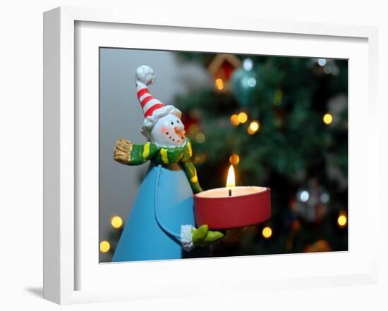 Close-Up of a Snow Man Candle in Front of a Tree with Christmas Lights-Winfred Evers-Framed Photographic Print