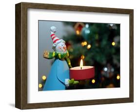 Close-Up of a Snow Man Candle in Front of a Tree with Christmas Lights-Winfred Evers-Framed Photographic Print