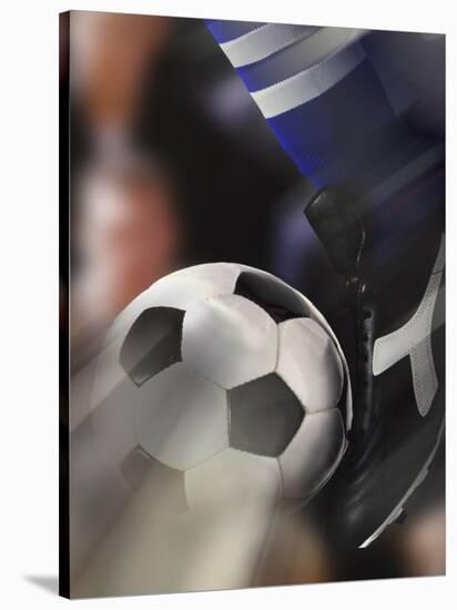 Close-up of a Soccer Player Kicking a Soccer Ball-null-Stretched Canvas