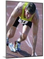 Close-up of a Young Man in the Starting Position on a Running Track-null-Mounted Photographic Print