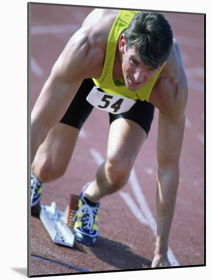 Close-up of a Young Man in the Starting Position on a Running Track-null-Mounted Photographic Print