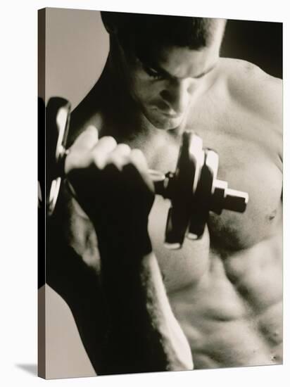 Close-up of a Young Man Working Out with a Dumbbell-null-Stretched Canvas