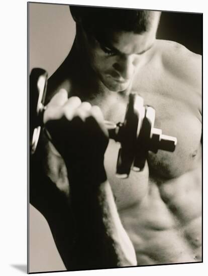 Close-up of a Young Man Working Out with a Dumbbell-null-Mounted Premium Photographic Print