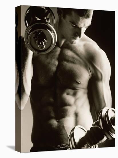 Close-up of a Young Man Working Out with Dumbbells-null-Stretched Canvas
