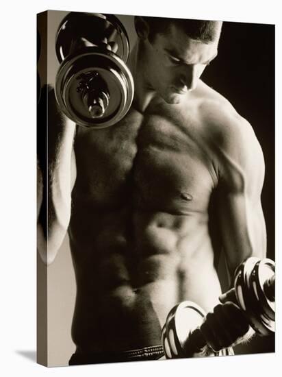 Close-up of a Young Man Working Out with Dumbbells-null-Stretched Canvas