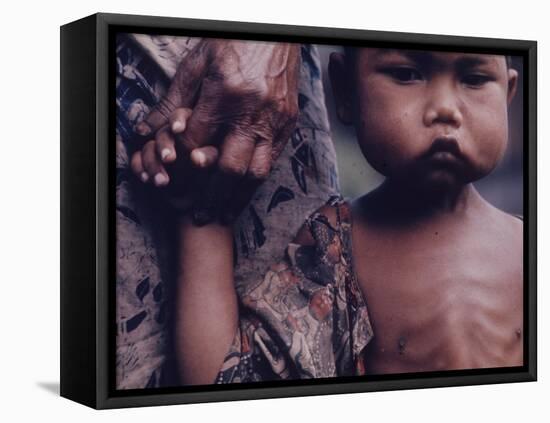 Close-Up of an Indonesian Child Holding on to the Hand of His Mother-Co Rentmeester-Framed Stretched Canvas