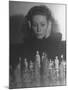 Close Up of Danielle Darrieux Looking at Chess Pieces-David Scherman-Mounted Premium Photographic Print