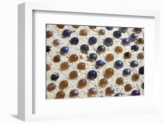 Close up of glass marbles in sand-John Gollings-Framed Photo