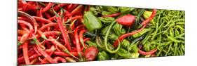 Close-Up of Green and Red Chili Peppers at Market Stall-null-Mounted Photographic Print