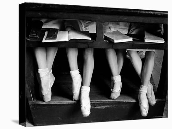 Close Up of Legs of Young Ballerinas in Toe Shoes under Desk at La Scala Ballet School-Alfred Eisenstaedt-Stretched Canvas