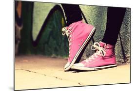 Close up of Pink Sneakers Worn by a Teenager. Grunge Graffiti Wall, Concepts of Teen Rebel, Problem-Michal Bednarek-Mounted Photographic Print