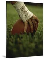 Close-up of the Hand of an American Football Player Holding a Football-null-Stretched Canvas