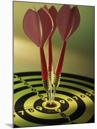 Close-up of Three Darts in the Bull's-Eye of a Dartboard-null-Mounted Premium Photographic Print
