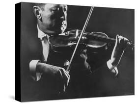 Close Up of Violinist Jascha Heifetz Playing in Mili's Darkened Studio-Gjon Mili-Stretched Canvas