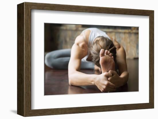 Close up of Young Woman Practicing Yoga, Sitting in Head to Knee Forward Bend Exercise, Janu Sirsas-fizkes-Framed Photographic Print