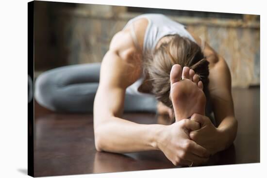 Close up of Young Woman Practicing Yoga, Sitting in Head to Knee Forward Bend Exercise, Janu Sirsas-fizkes-Stretched Canvas