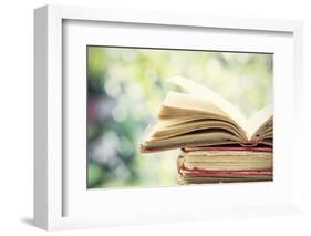 Close up on Old Book on Colorful Bokeh Background-melis-Framed Photographic Print