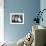 Close-Up Photograph of Feet in a Pair of White Platform Sandals-null-Framed Photographic Print displayed on a wall