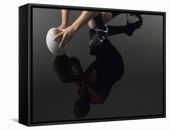 Closeup Low Section and Reflection of a Rugby Player Kneeling on One Knee with Ball-Nosnibor137-Framed Stretched Canvas