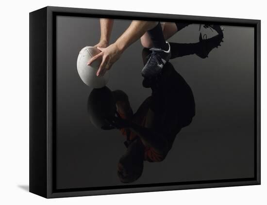 Closeup Low Section and Reflection of a Rugby Player Kneeling on One Knee with Ball-Nosnibor137-Framed Stretched Canvas