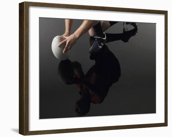 Closeup Low Section and Reflection of a Rugby Player Kneeling on One Knee with Ball-Nosnibor137-Framed Photographic Print