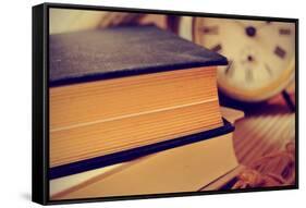 Closeup of a Pile of Old Books and an Old Alarm Clock on a Desk, with a Retro Effect-nito-Framed Stretched Canvas