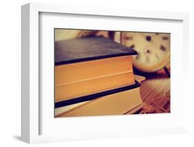 Closeup of a Pile of Old Books and an Old Alarm Clock on a Desk, with a Retro Effect-nito-Framed Photographic Print