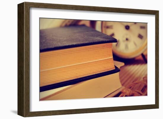 Closeup of a Pile of Old Books and an Old Alarm Clock on a Desk, with a Retro Effect-nito-Framed Photographic Print