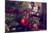 Closeup of Red Bauble Hanging from a Decorated Christmas Tree. Retro Filter Effect.-Gajus-Mounted Photographic Print