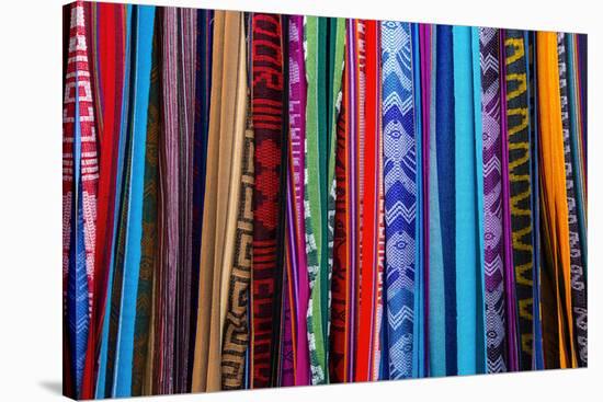 Cloths, Blankets, Scarves, and Hammocks Hang on Display at the Otavalo Market, in Otavalo, Ecuador-Karine Aigner-Stretched Canvas