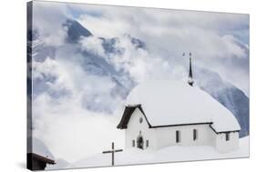 Clouds Above the Mountain Huts and Church Covered with Snow, Bettmeralp, District of Raron-Roberto Moiola-Stretched Canvas