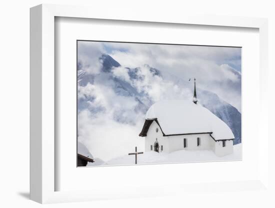 Clouds Above the Mountain Huts and Church Covered with Snow, Bettmeralp, District of Raron-Roberto Moiola-Framed Photographic Print