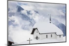 Clouds Above the Mountain Huts and Church Covered with Snow, Bettmeralp, District of Raron-Roberto Moiola-Mounted Photographic Print