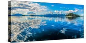 Clouds and sky reflected in the calm waters of the Inside Passage, Southeast Alaska, USA-Mark A Johnson-Stretched Canvas