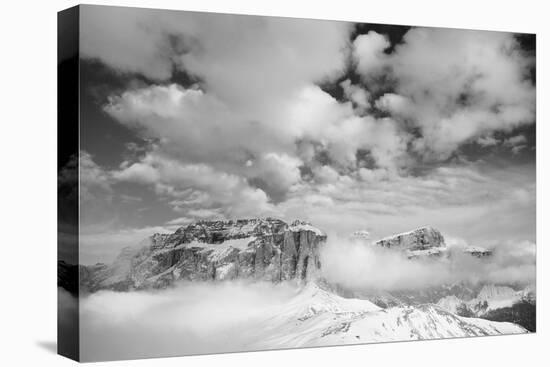 Clouds hang between the mountains of the Dolomites-Jean Schwarz-Stretched Canvas