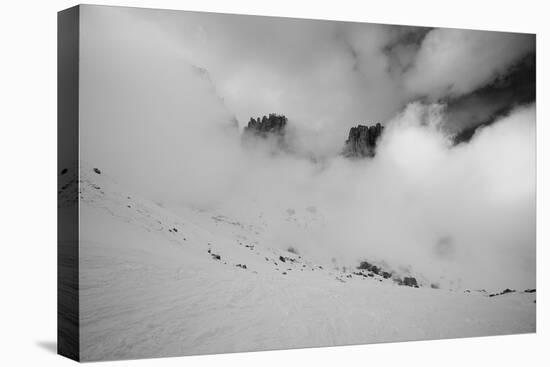 Clouds hang between the mountains of the Dolomites-Jean Schwarz-Stretched Canvas