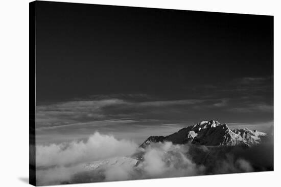 Clouds hang between the mountains of the Dolomites-Jean Schwarz-Stretched Canvas