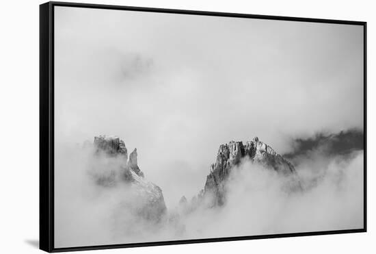 Clouds hang between the mountains of the Dolomites-Jean Schwarz-Framed Stretched Canvas